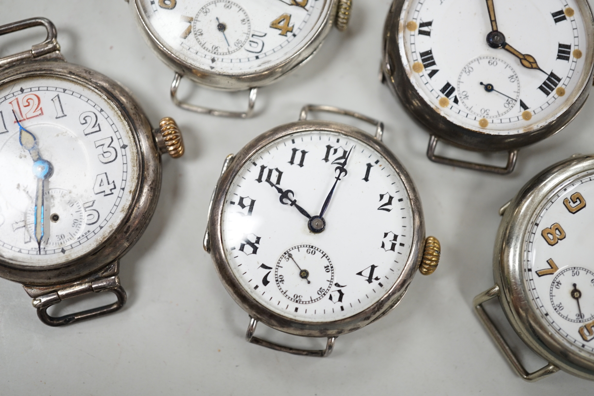 Five assorted early to mid 20th century manual wind wrist watches, including four silver.